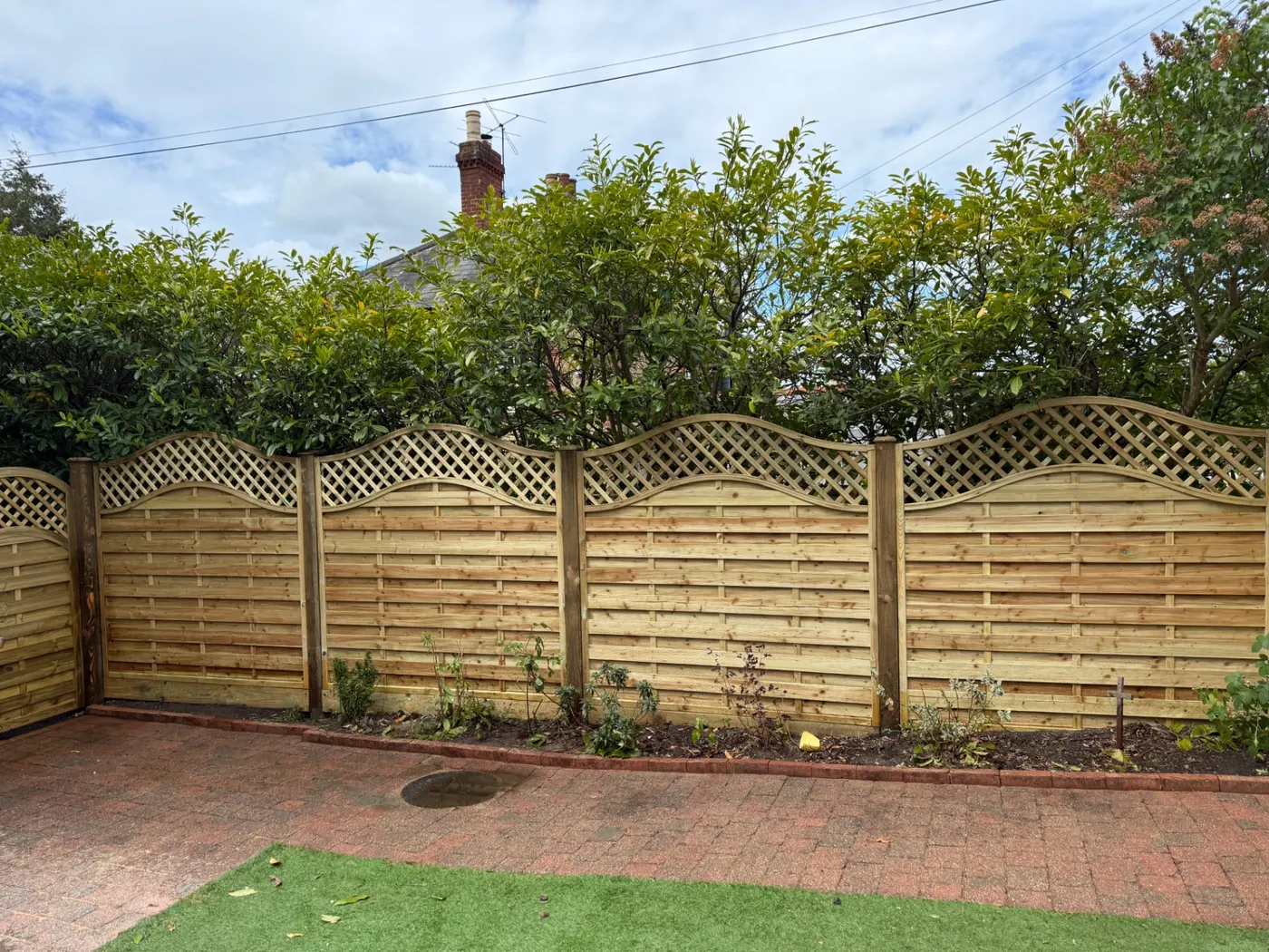 Trellis topped garden fence panels in a back garden